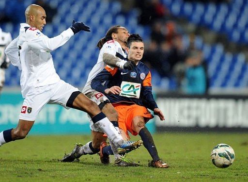 Montpellier's Remy Cabella (R), Sochaux's Carlos Roberto da Cruz Junior (L) and Roy Contout (C) on January 23, 2013